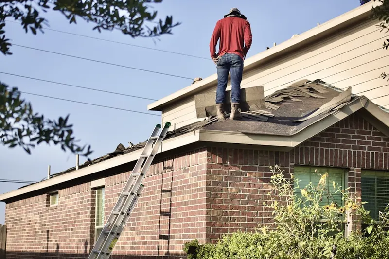Professional roofer working on a residential roof in Lochwood Estates